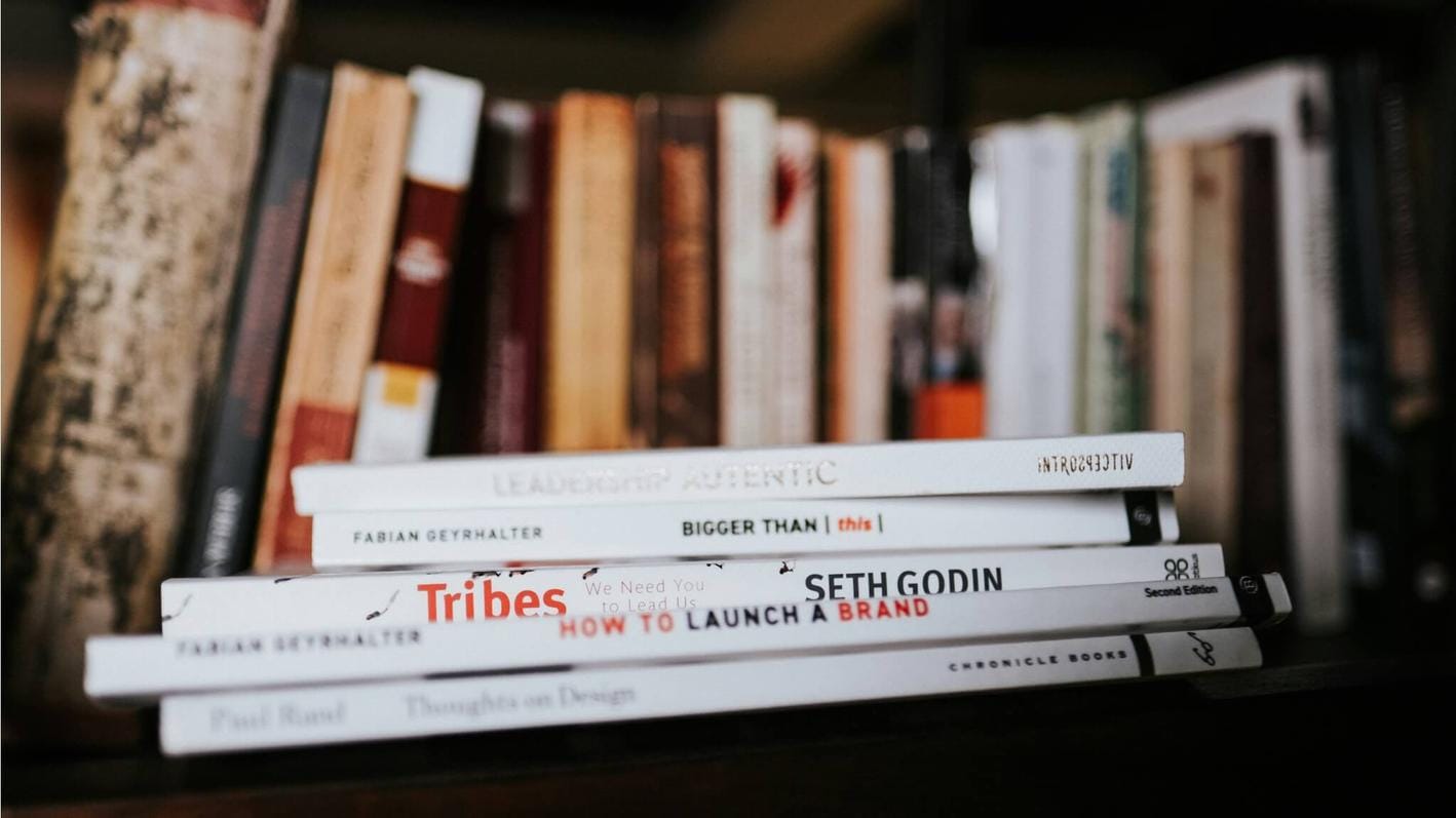 Stack of books with a couple of by Seth Godin visible